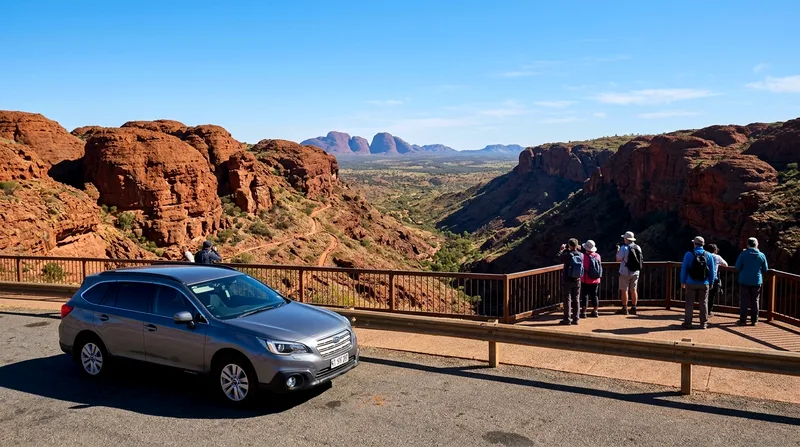 Parked car at lookout point with Valley of the Winds gorge visible below.