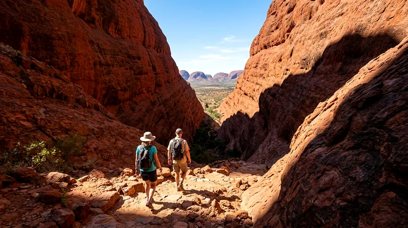 Hikers descending into the Valley of the Winds between steep red-rock walls.